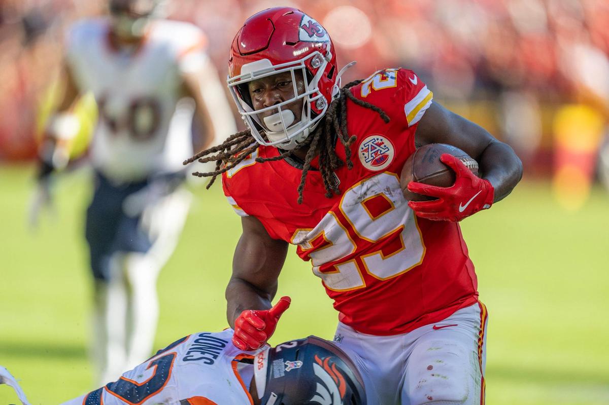 Kansas City Chiefs running back Kareem Hunt (29) is tackled by Denver Broncos safety Brandon Jones (22) in the third quarter during an NFL game on Sunday, Nov. 10, 2024, at GEHA Field at Arrowhead Stadium.