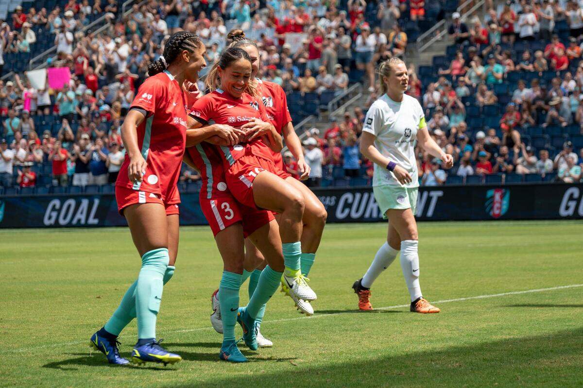 Kansas City Current midfielder Lo’eau LaBonta celebrates with teammates after scoring a penalty kick in the first half on May 30, 2022 at Children’s Mercy Park. The Current beat Racing Louisville 1-0.
