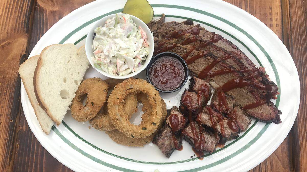 Luther’s Brisket Dinner with sliced smoked brisket, burnt ends and a choice of two sides such as onion rings and creamy coleslaw costs $20.