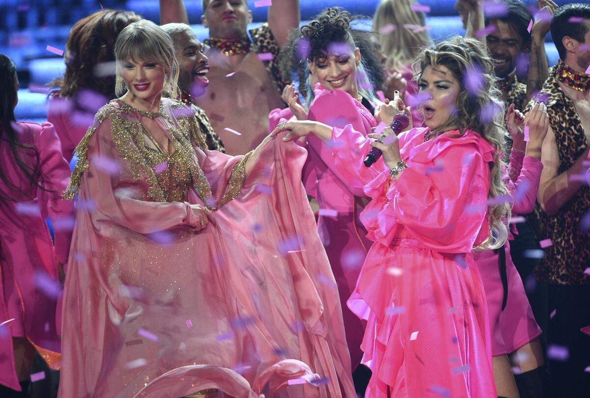Taylor Swift, left, winner of the artist of the year award, and Shania Twain, right, are pictured at the conclusion of the American Music Awards on Nov. 24, 2019, at the Microsoft Theater in Los Angeles.