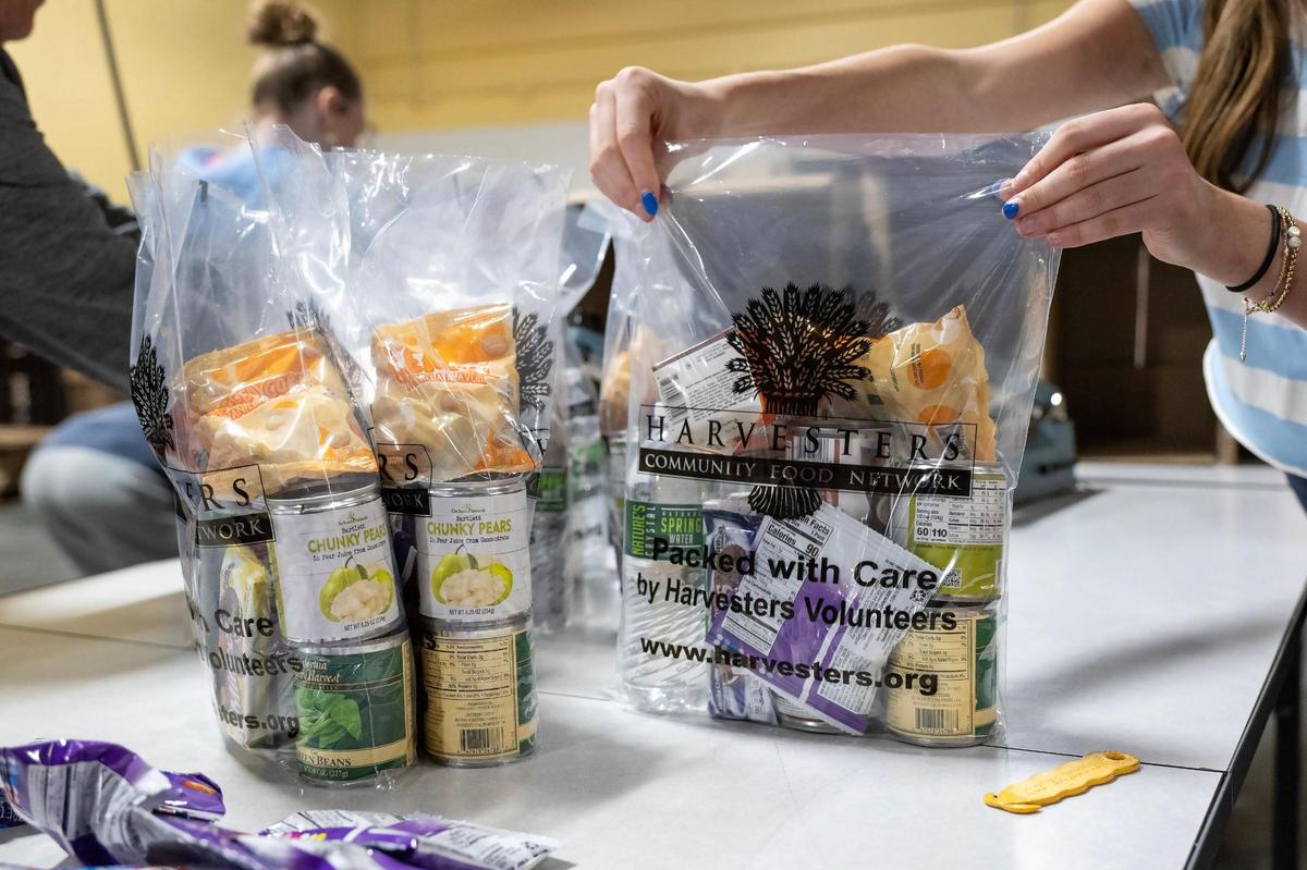 Volunteers sealed BackSnacks at Harvesters on the MLK Day of Service on Monday, Jan. 20, 2025, in Kansas City. The BackSnacks program provides meals for elementary and some middles school students to take home over the weekend.