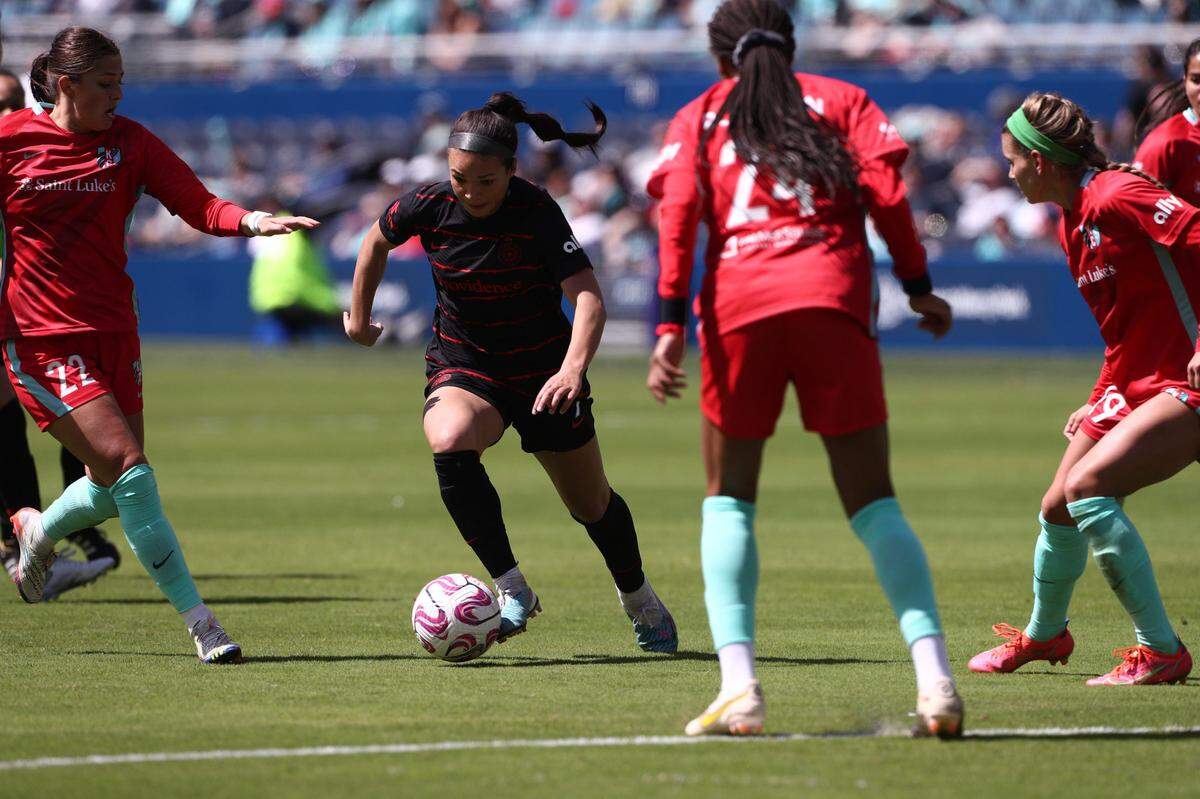 Portland Thorns FC forward Sophia Smith (9) dribbles past the Kansas City Current players during the second half at Children’s Mercy Park on April 1, 2023.