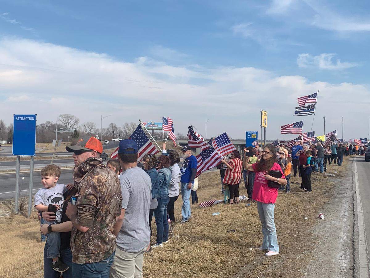 Supporters gather outside a truck stop in Oak Grove, Missouri to cheer on the “Freedom Convoy.”