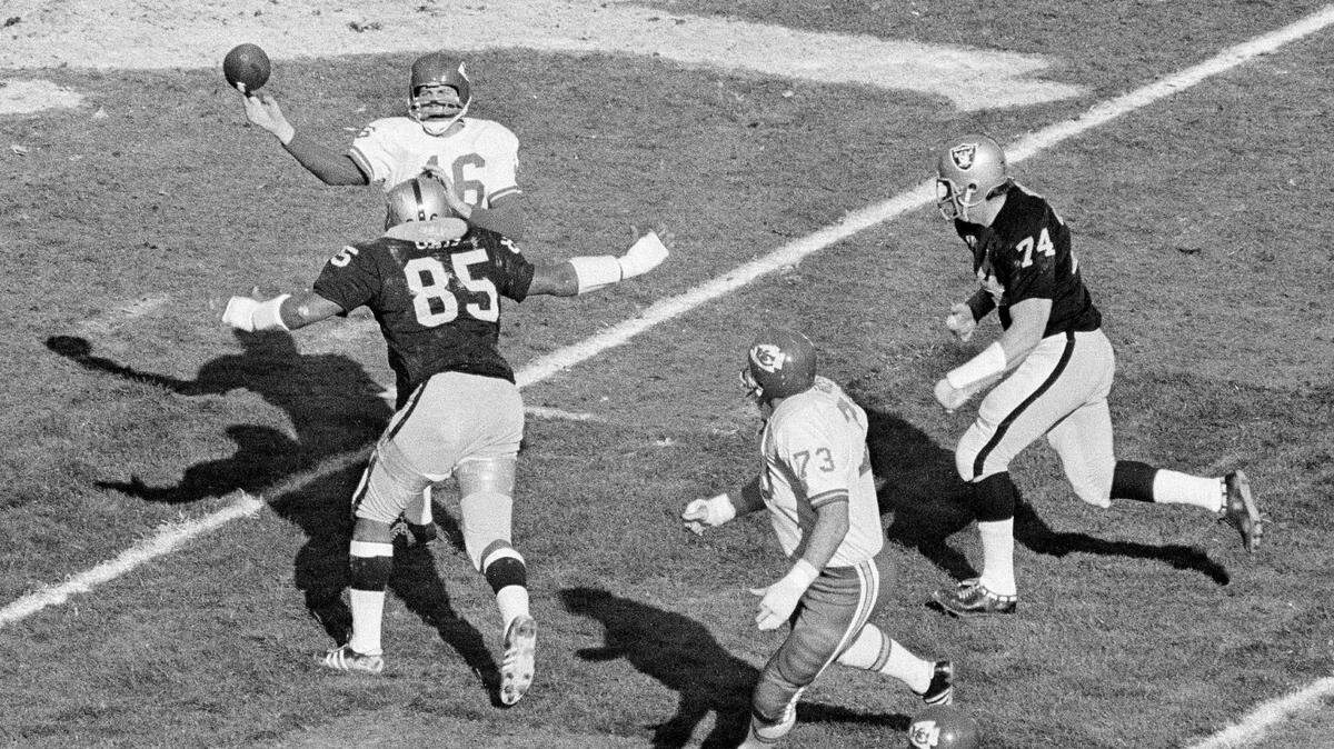 Chiefs quarterback Len Dawson (No. 16) passes the ball with Raiders defensive tackle Carleton Oats (No. 85) bearing down on him during the AFL Championship Game in Oakland, Calif. on Jan. 4, 1970. The Chiefs won 17-7.