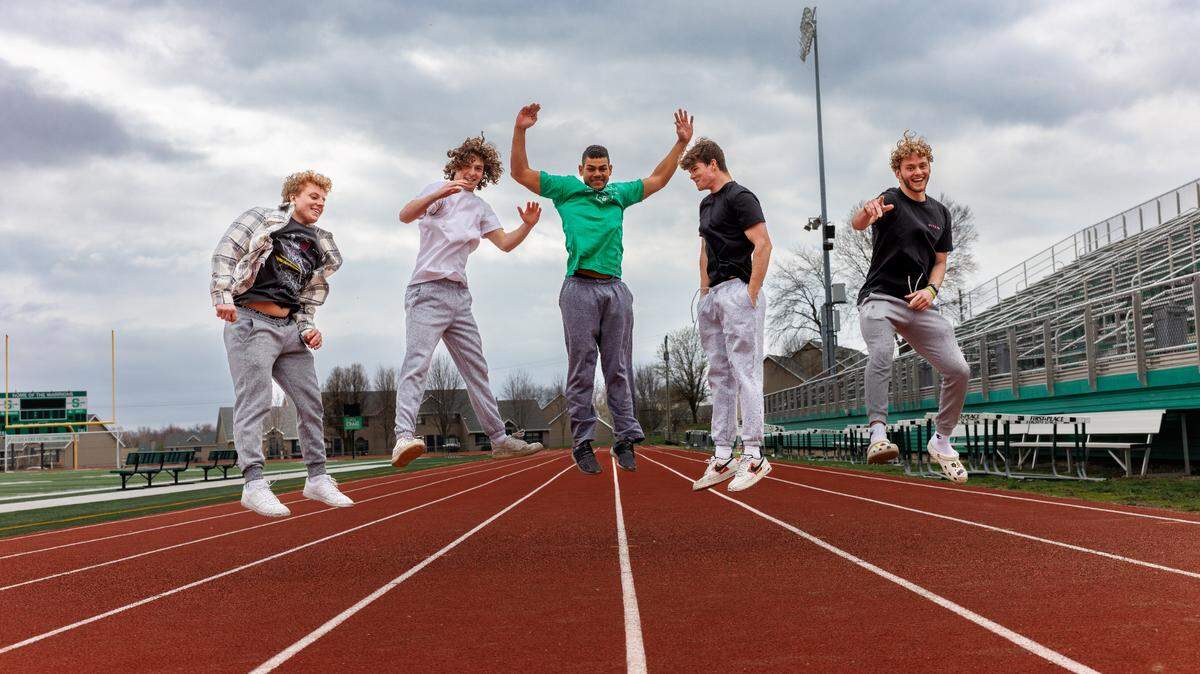 Caleb, Noah, Eli, Tristan, and Dawson, five members of the Class of 2023, jump for joy.