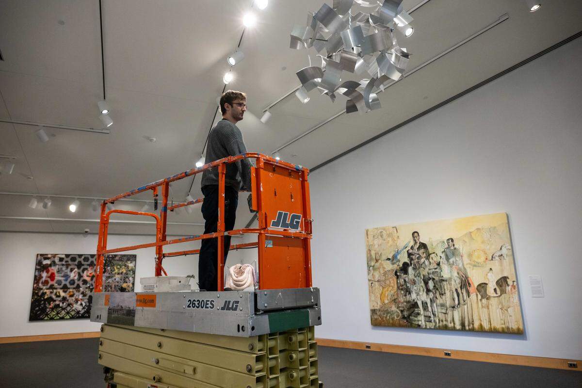 Preparatory Will Preman helps put finishing touches on “The World in Kansas City,” an art exhibition showcasing work from artists' that have connections to Kansas City, on Thursday, March 5, 2026, at the Kemper Museum of Contemporary Art.