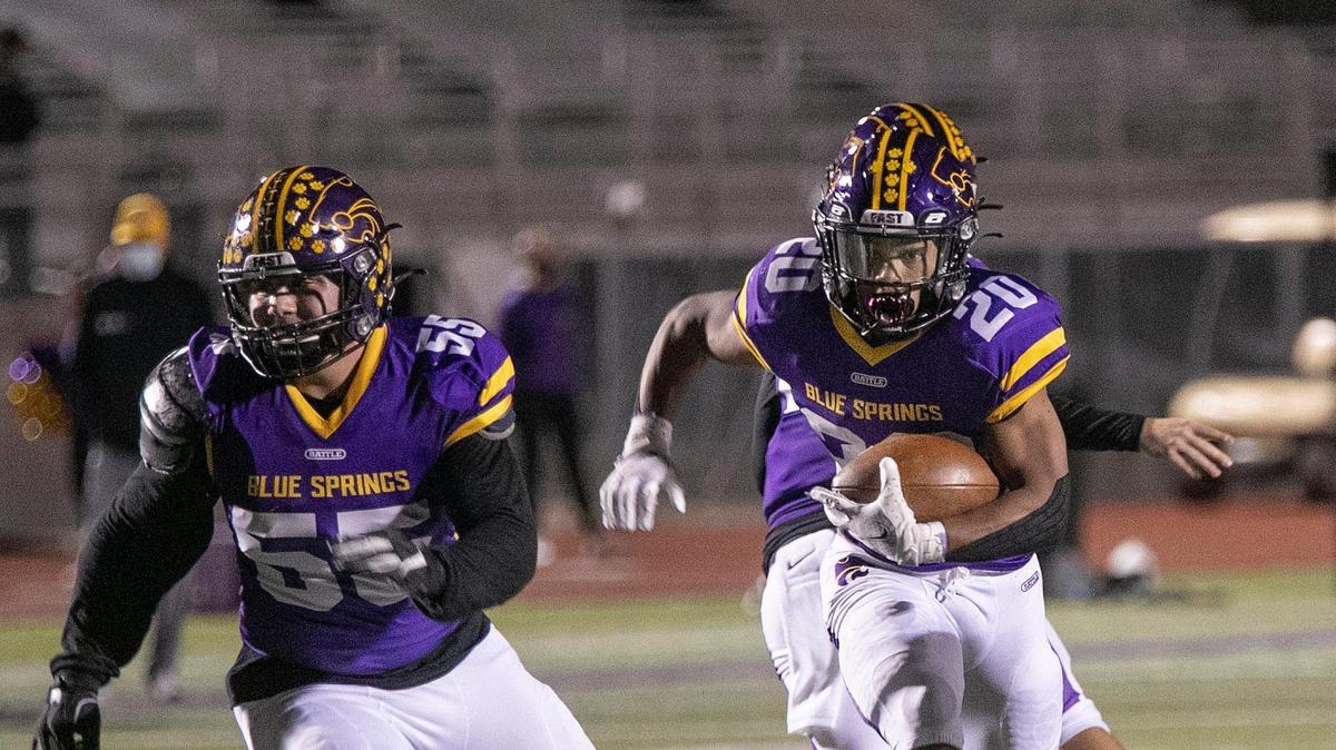 Guarded by Donovan Romero #55, DeAndre Thomas, #20 of Blue Springs carried the ball during the game against Park Hill, Friday, October 30, 2020, at Blue Springs.