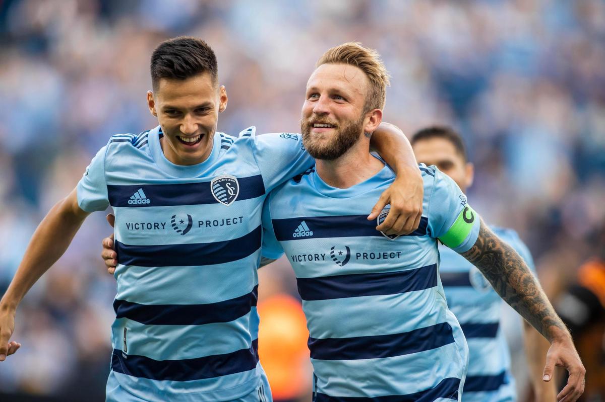 Sporting Kansas City forward Johnny Russell, right, celebrates with forward Daniel Salloi after scoring the opening goal against the Houston Dynamo on Sunday at Children’s Mercy Park in Kansas City, Kan.