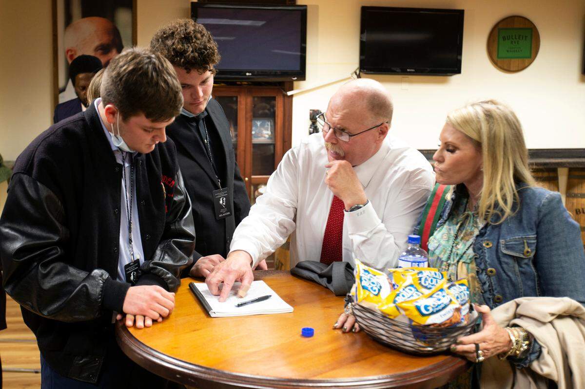 Chiefs coach Andy Reid, second from right, talks football with Jesse Madden, left, and cousin Aidan Madden before a memorial service for former NFL coach and television commentator John Madden last Monday in Oakland, Calif.
