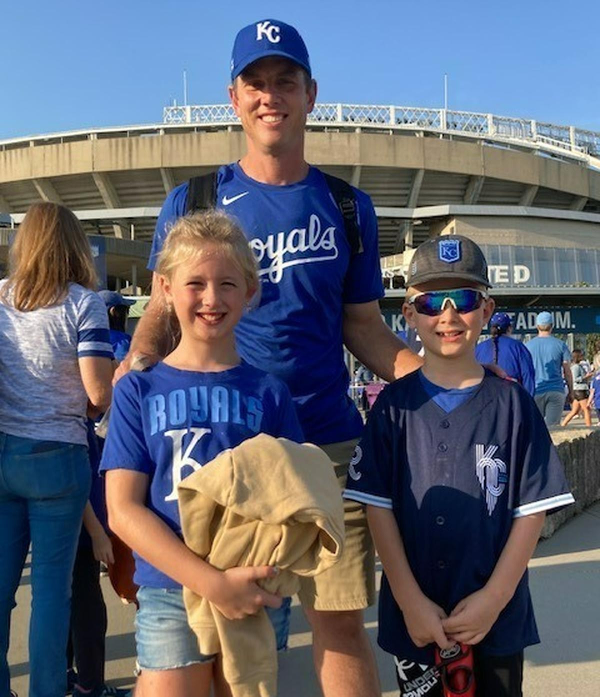 Maddie Glick, 9, and Henry Glick, 7, with their dad, Trent Glick, from Wetmore, Kansas. Dad recalls the 2014 and 2015 Royals with great fondness. For his kids, Bobby Witt Jr. is the stuff of their memories.