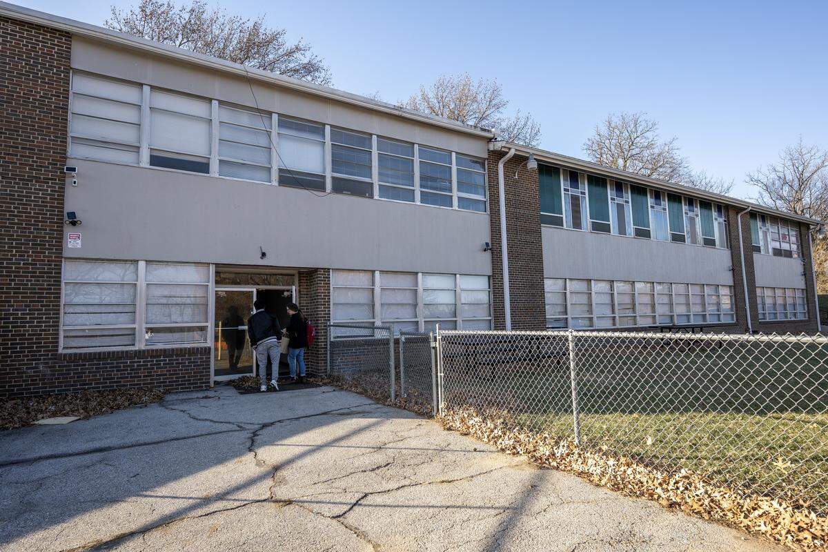 Mayson Victor, 20, of Haiti, left, and Meaghan Fanning, youth social work manager at Jewish Vocational Services, enter the JVS youth services building at 1903 Hardesty Ave.