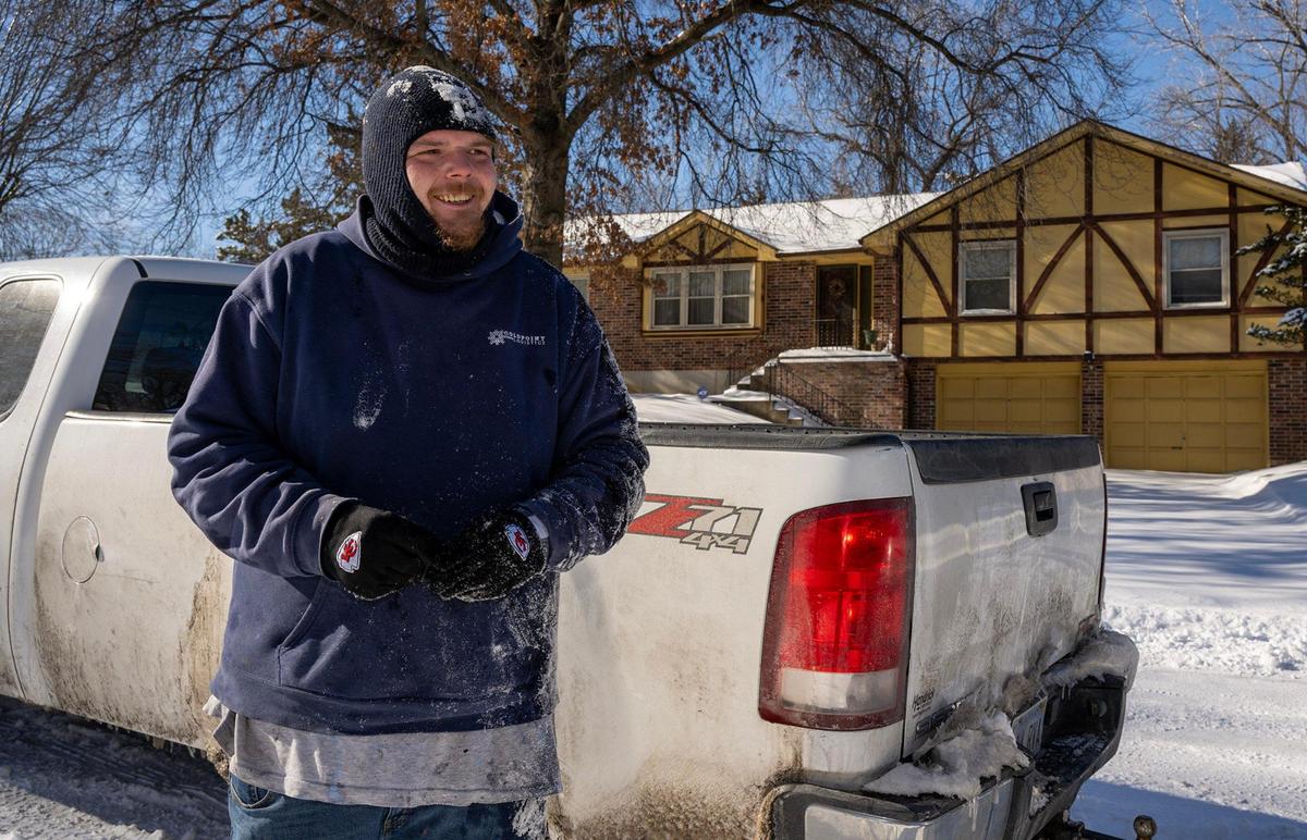 Corey Sutton smiles after pulling a truck from a snowbank for Kendall Amos on Tuesday, Jan. 7, 2025, in Kansas City, Kansas.