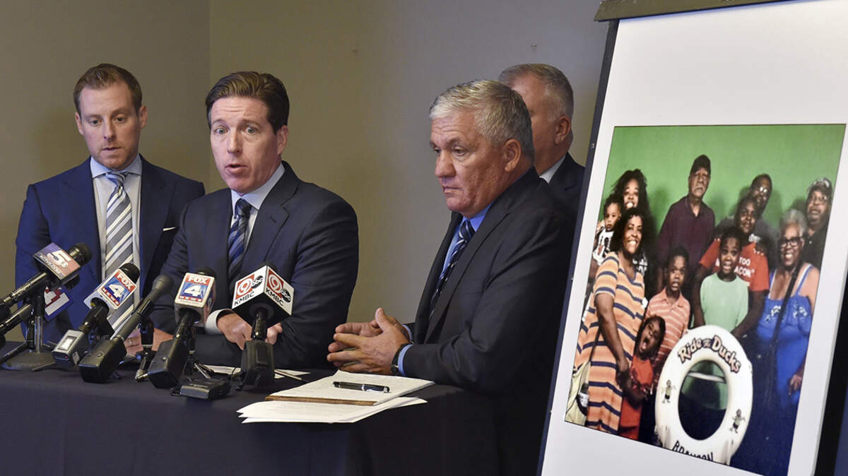 During a press conference on July 30 in Kansas City, attorney Andrew Duffy, middle, spoke about the lawsuit being filed on behalf of the family pictured at right, who lost nine members during the duck boat accident on Table Rock Lake.