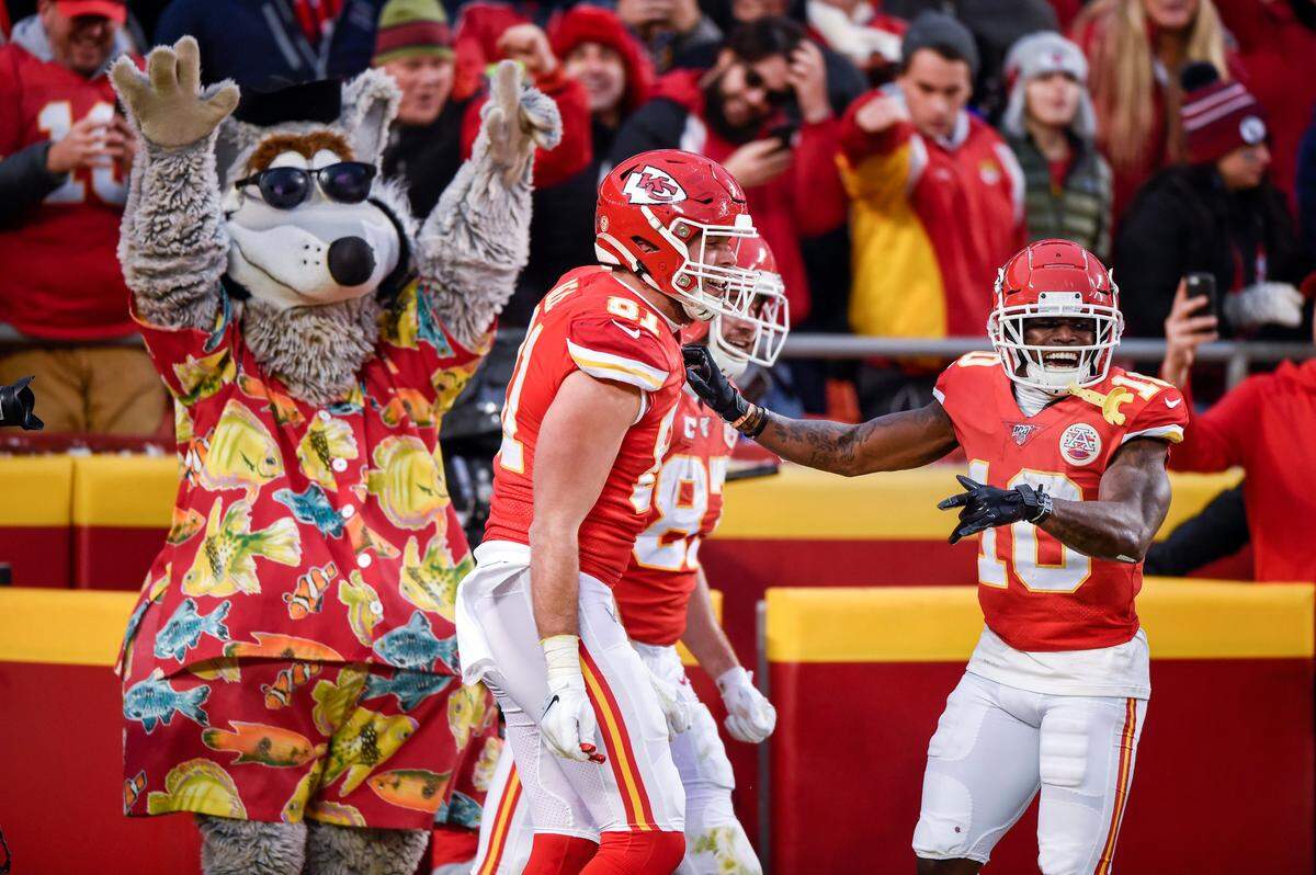 Chiefs receiver Tyreek Hill, right, and KC Wolf help tight end Blake Bell, center, celebrate his touchdown late in the fourth quarter against Houston last weekend at Arrowhead Stadium.