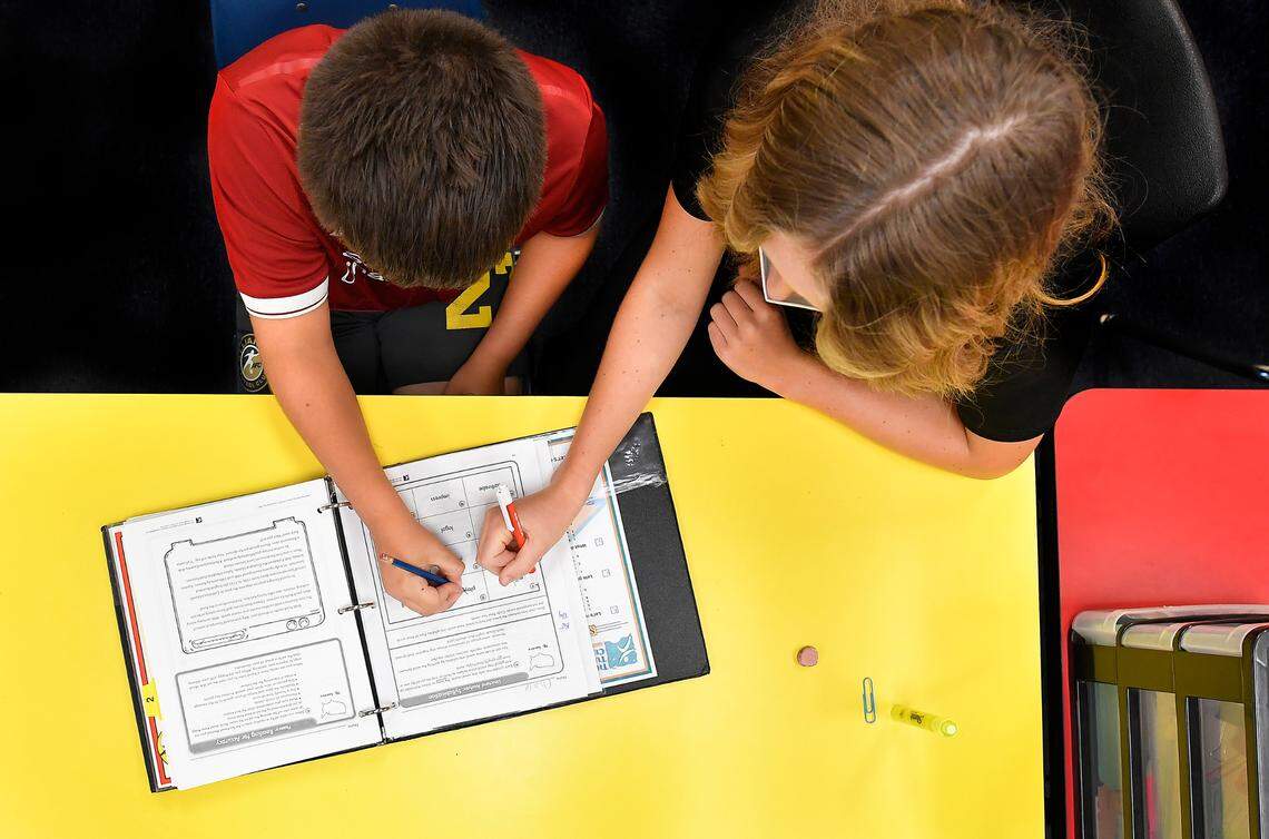 At The Tutoring Center near Liberty, Chase Wisdom, 10, completes work under the watchful eye of his tutor, Baily Wisdom. Chase was preparing to be a fifth grader at Liberty’s Franklin Elementary School this fall.