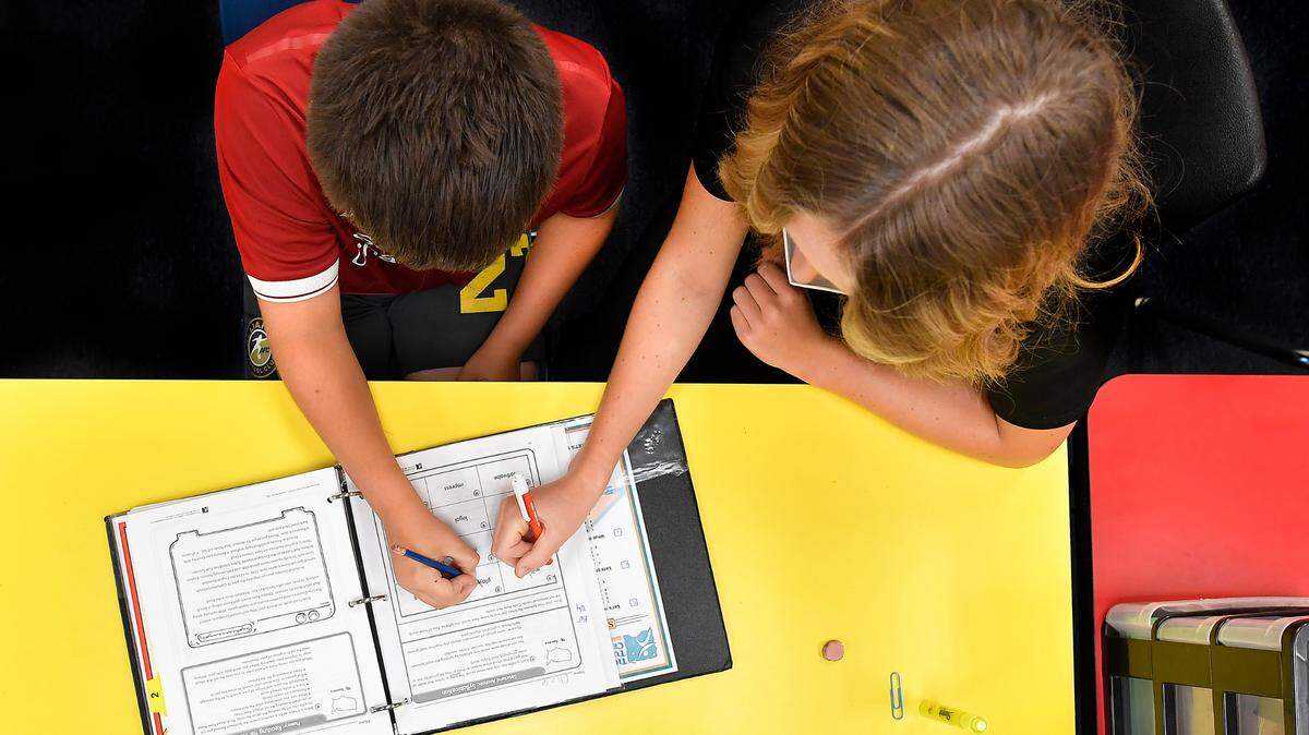 At The Tutoring Center near Liberty, Chase Wisdom, 10, completes work under the watchful eye of his tutor, Baily Wisdom. Chase was preparing to be a fifth grader at Liberty’s Franklin Elementary School this fall.