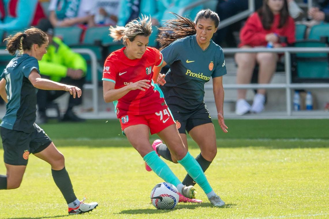 Kansas City Current forward Claire Lavogez (94) battles Portland Thorns defender Reyna Reyes (2) for the ball in the second half of an NWSL match at CPKC Stadium on Saturday, March 16, 2024, in Kansas City.