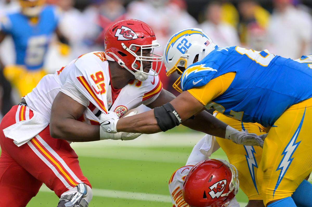 Kansas City Chiefs defensive tackle Chris Jones (95) and Los Angeles Chargers center Sam Mustipher (62) battle at the line in the second half at SoFi Stadium.