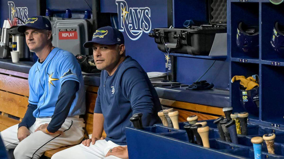 Tampa Bay Rays bench coach Matt Quatraro, left, and manager Kevin Cash sit in the dugout before the start of a game in June. Quatraro was hired Sunday as the Royals’ new manager.