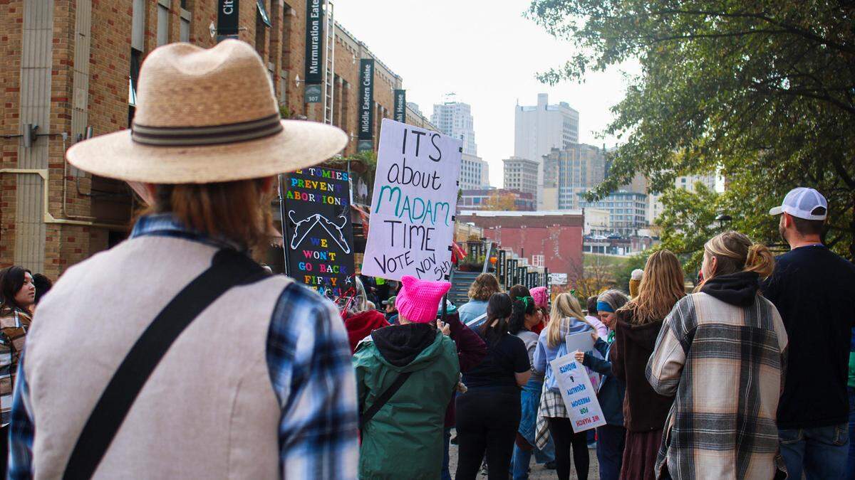 People carrying picket signs gather in Kansas City’s River Market neighborhood for a march advocating for reproductive rights on Nov. 2, 2024.