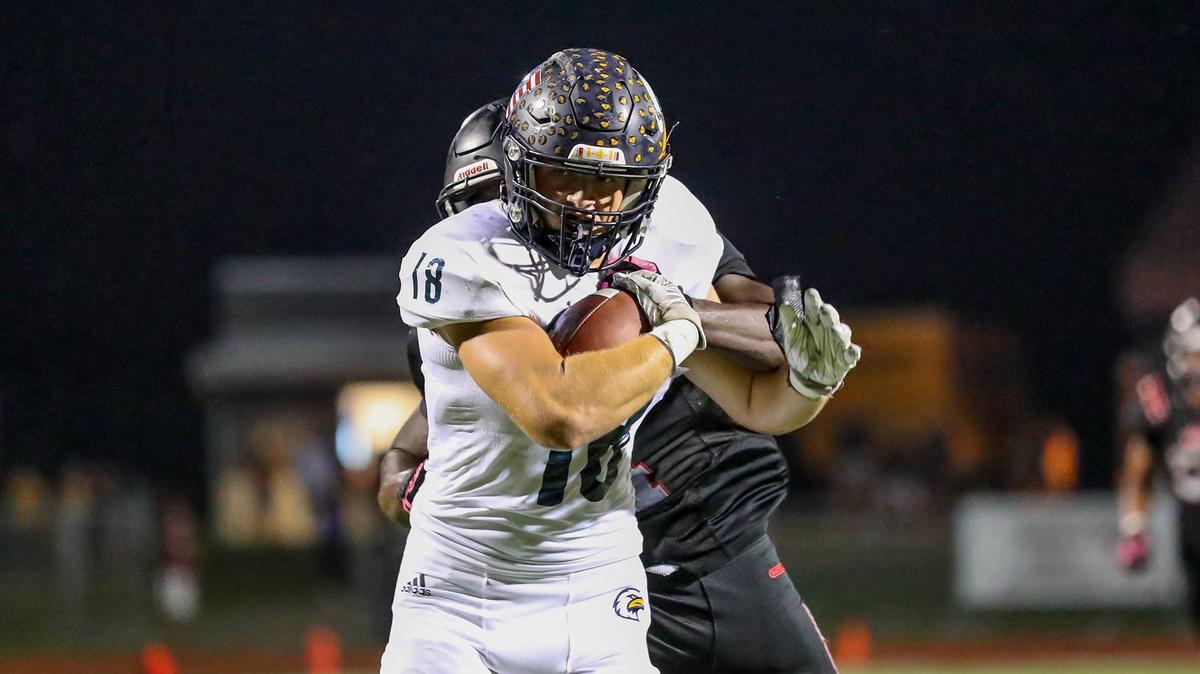 Liberty North’s Justis Braden (18) makes it in for touchdown with Lee’s Summit North’s Dewaun Mack in tow on October 8, 2021, in Lee’s Summit.