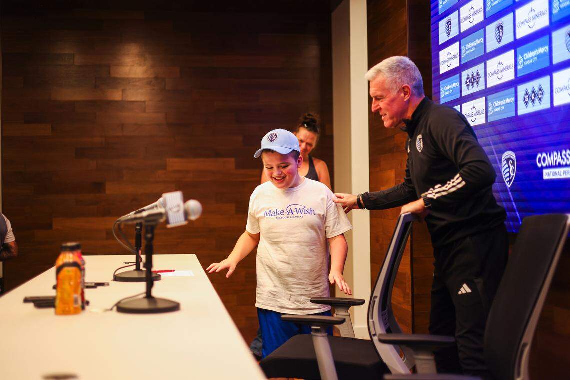 Eleven-year-old Miles Smith and Sporting KC manager Peter Vermes during a news conference to announce Smith’s “signing” with the club.