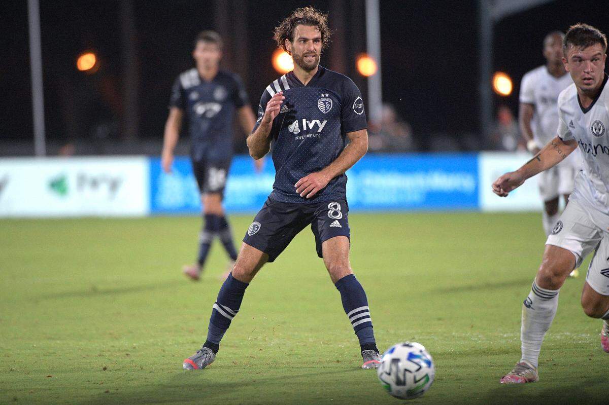 Sporting Kansas City midfielder Graham Zusi passes the ball in front of Philadelphia Union defender Kai Wagner during a match Thursday, July 30, 2020, in Kissimmee, Fla.