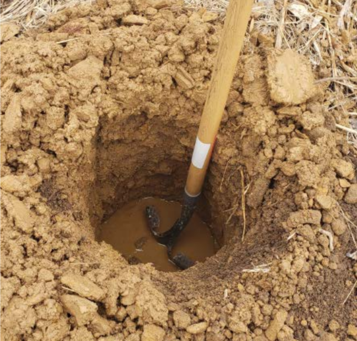 A hole filled with water at the site of a proposed concentrated animal feeding operation in Livingston County, Mo.