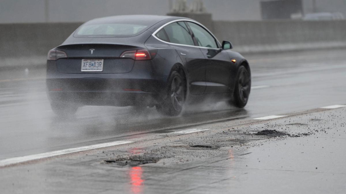 A vehicle drives past recently repaired potholes on southbound I-35 near Cambridge Circle in Wednesday in Kansas City. Potholes in that area were repaired after there were reports of several cars being damaged Wednesday morning.