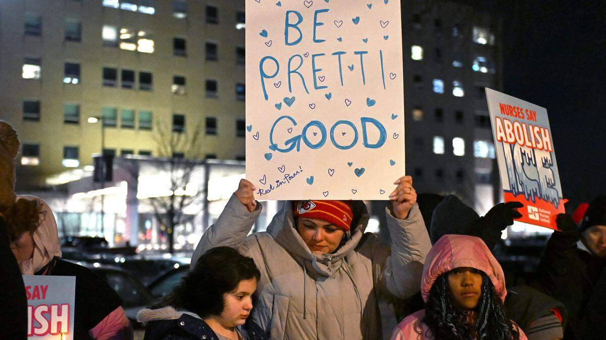 Jessica Bertocci, holds a sign while attending a candlelight vigil outside Research Medical Center to honor Alex Pretti on Thursday, Jan. 29, 2026, in Kansas City.