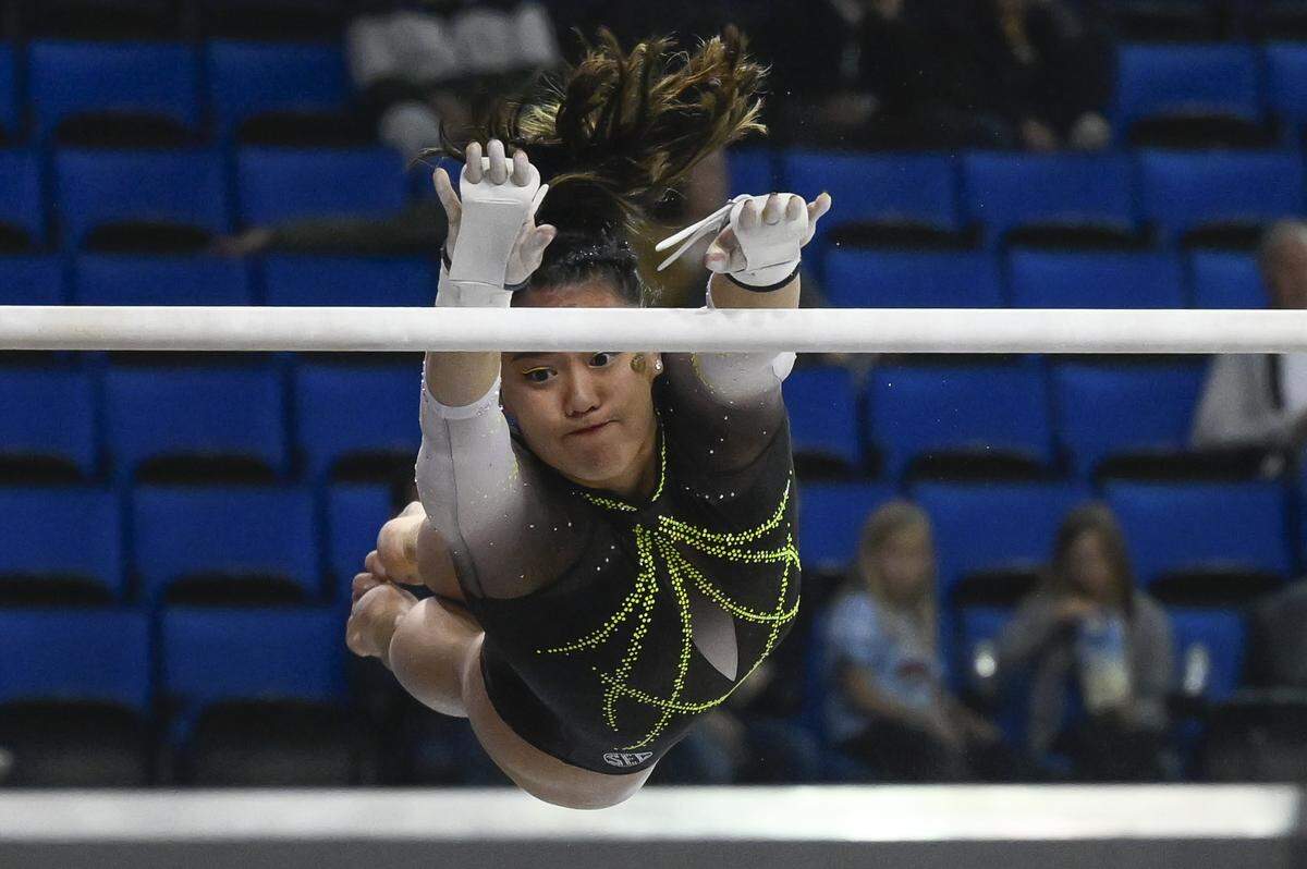 Missouri Tigers All-American Helen Hu hangs in the air as she competes on the uneven bars during the NCAA Women’s Gymnastics Los Angeles Regional at Pauley Pavilion on March 30, 2023. Hu stuck to the beam in the 2025 season, becoming an individual national champion.