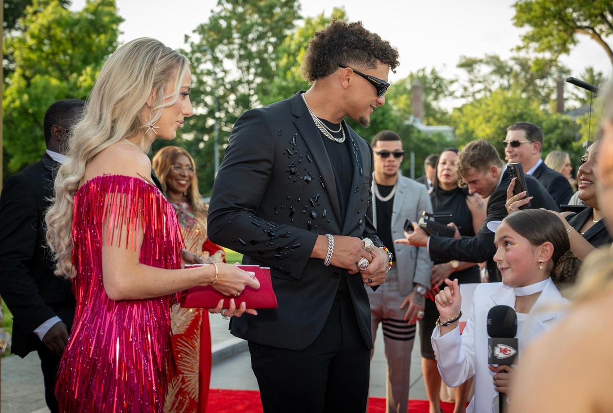 Brittany Mahomes and Patrick Mahomes, Chiefs quarterback, talk to Taylen Biggs, a social media personality, as they walked the red carpet before the Super Bowl LVIII championship ring presentation event on Thursday at The Nelson-Atkins Museum in Kansas City.