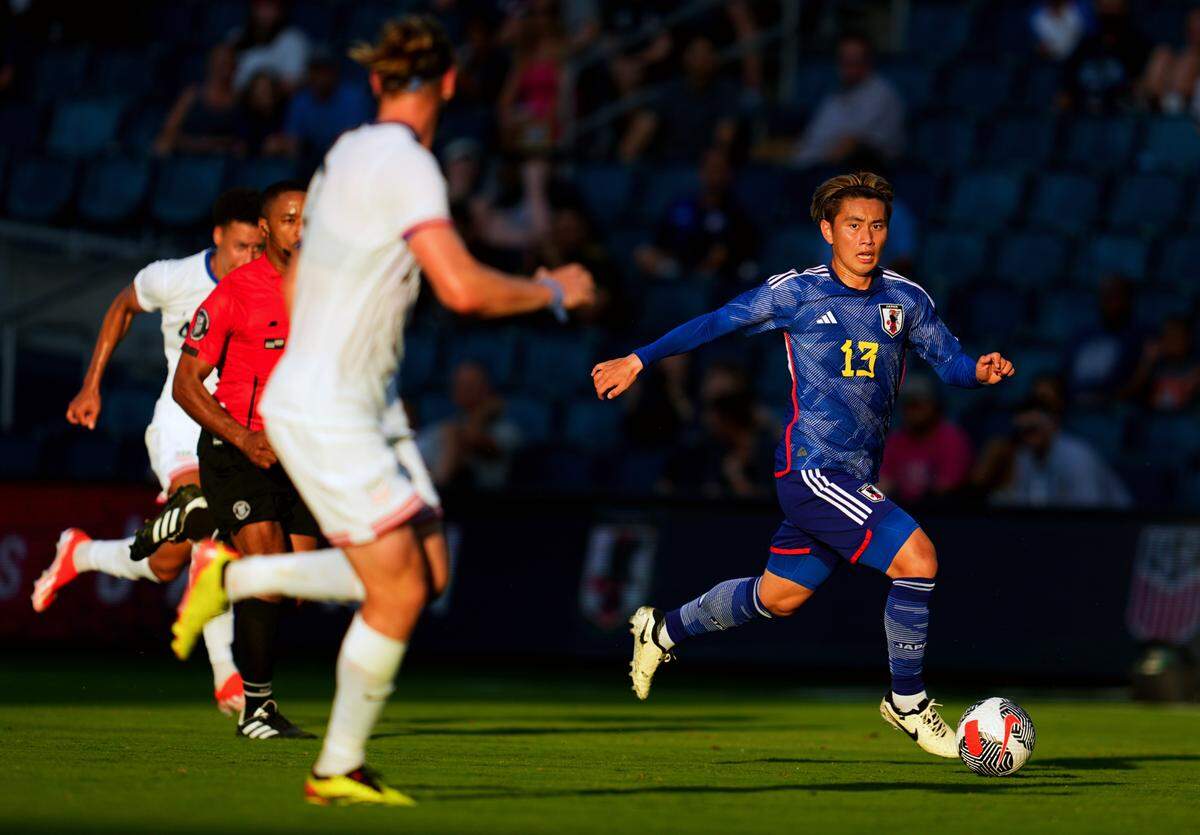 Japan forward Ryotaro Araki (13) brings the ball up the pitch during the first half against the United States at Children’s Mercy Park on June 11, 2024.