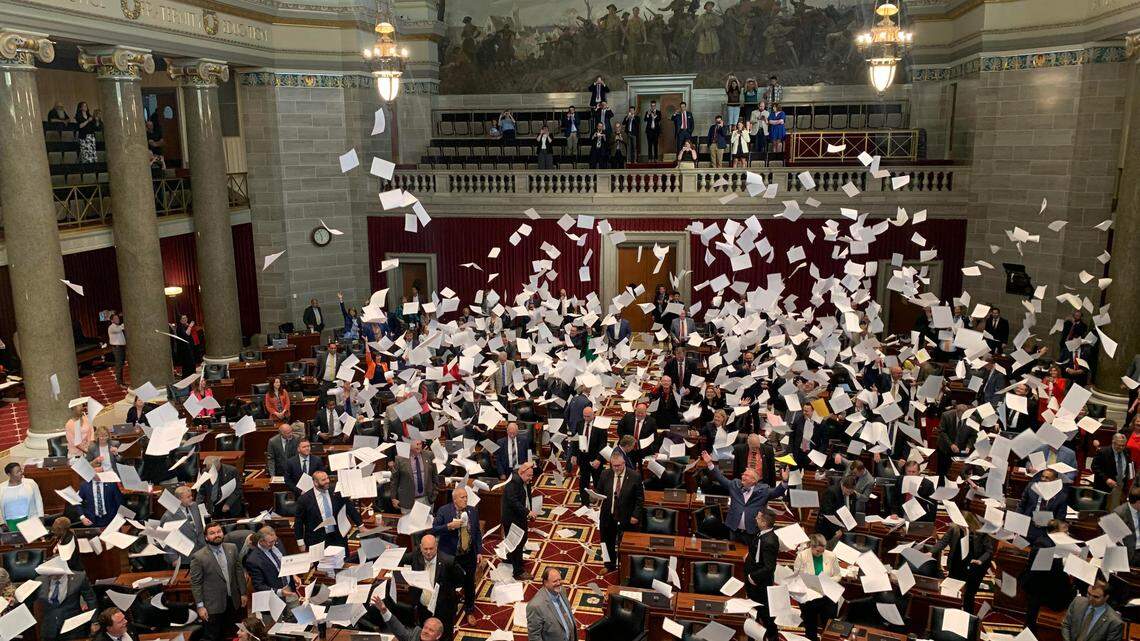 Lawmakers throw paper in the air as the Missouri House adjourns on Friday, May 12, 2023.