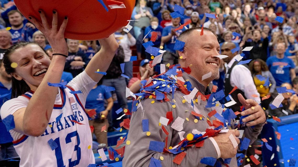 Kansas guard Holly Kersgieter (13) showers head coach Brandon Schneider with confetti after defeating Columbia 66-59 in the WNIT championship game, Saturday, April 1, 2023, in Lawrence, Kan.