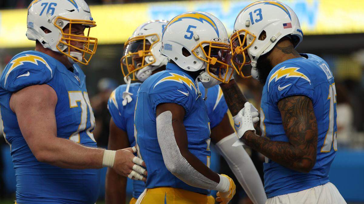 Los Angeles Chargers wide receiver Keenan Allen (13) celebrates with wide receiver Joshua Palmer (5) and center Will Clapp (76) after catching a touchdown pass during the first quarter against the Dallas Cowboys at SoFi Stadium.