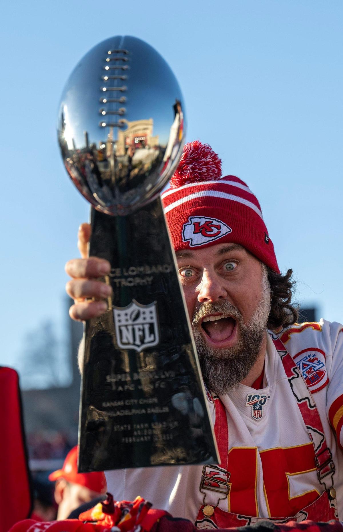 Chiefs fan Blair Falconer of Overland Park, cheered on the Chiefs and showed off his Lombardi Trophy before the Super Bowl LVIII championship parade and rally on Wednesday, Feb. 14, 2024, in Kansas City. Falconer won the replica Lombardi trophy in a raffle.