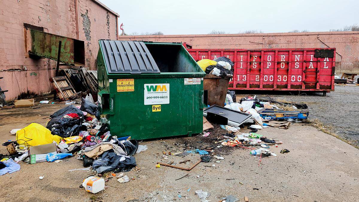 Trash litters the area behind the Robandee Shopping Center in south Kansas City.