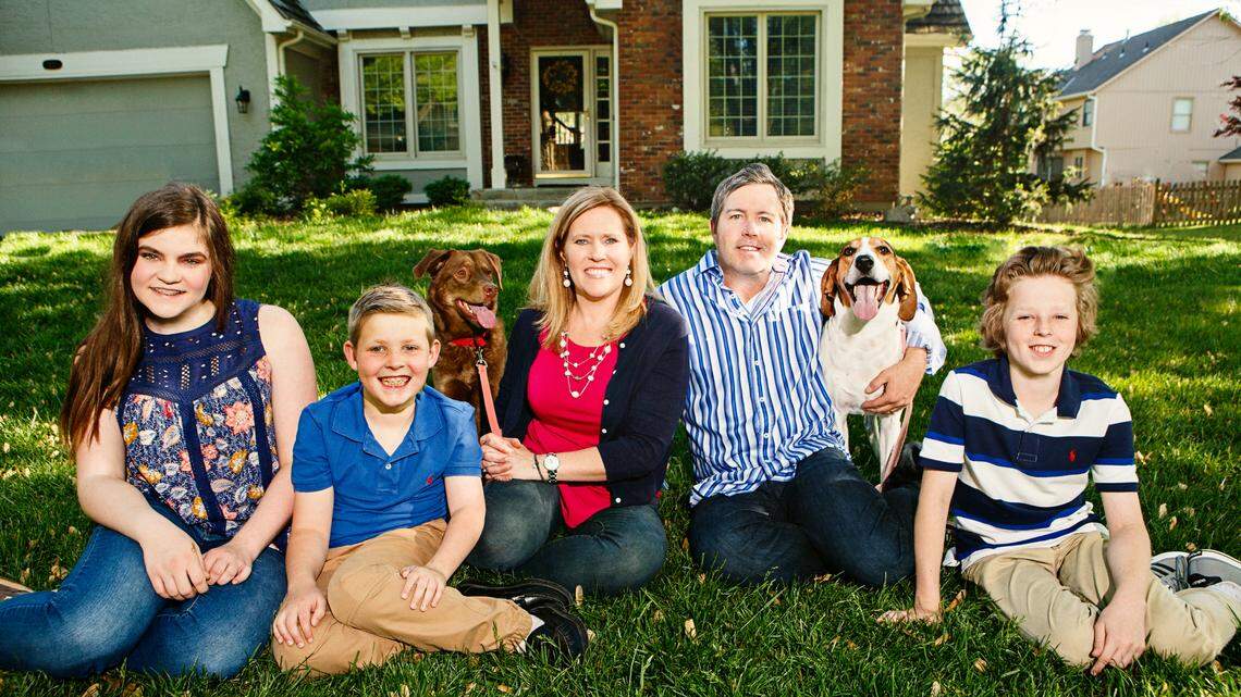 Chris and Christie Dennis, owners of GivePet, pose with their children and two of their dogs, Adela the lab mix and Fern the coonhound.