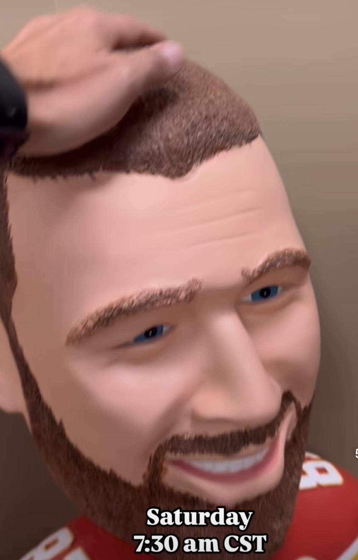 Hynes pats “Travis Kelce” on the head.