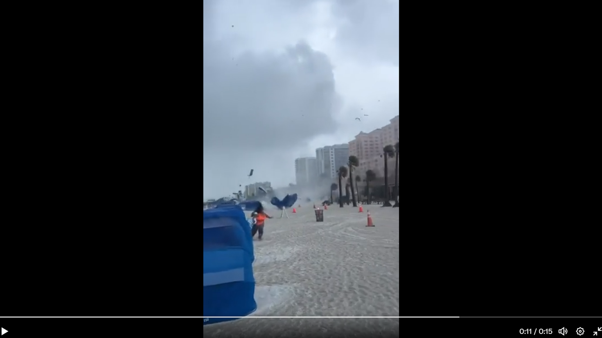 Debris flies as a waterspout moves along the Florida coast.
