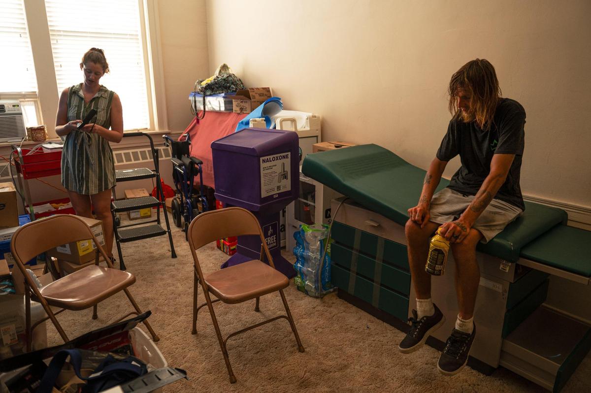 Kenlee Urban, left, retrieves a new cane for Chris Culp during a physical therapy session at the Independence Boulevard Christian Church in Kansas City. Urban has worked as a physical therapist for Care Beyond the Boulevard since March 2023.