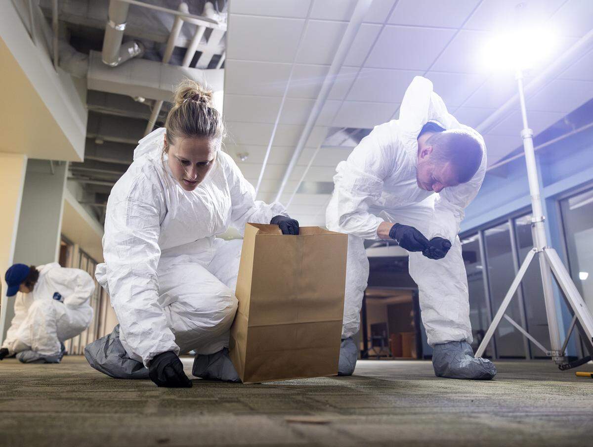 FBI staffers process a mock scene during a training event at an Overland Park office building on Wednesday, Sept. 17.