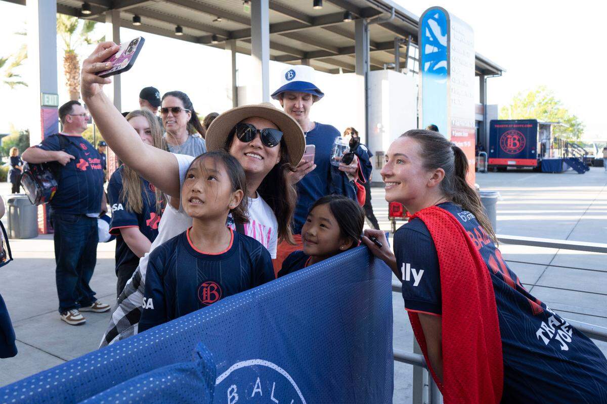 Bay FC midfielder Dorian Bailey, left, pauses for a photo with fans after an NWSL match against the Chicago Stars at PayPal Park in San Jose, California on April 13, 2025.