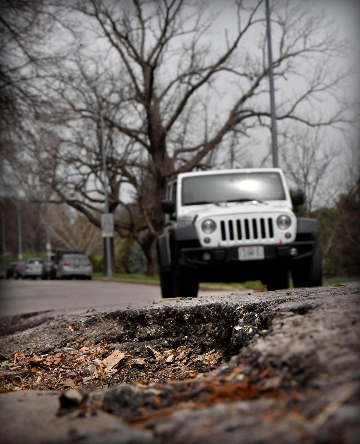 A large pothole looms near the intersection of 55th Street and Summit Avenue., in Kansas City.