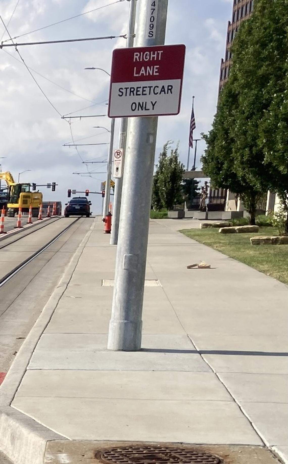 A street sign along Main Street clearly tells motoriist that the right is only for the streetcar.
