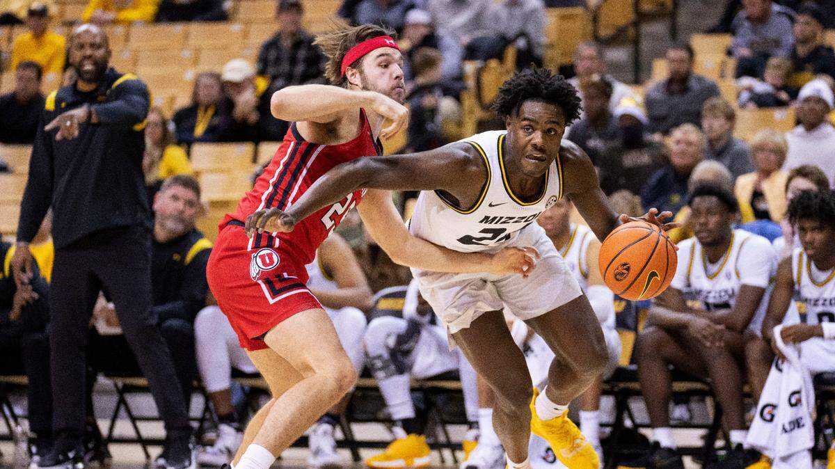 Missouri’s Kobe Brown, right, drives past Utah’s Rollie Worster, left, during the second half of an NCAA college basketball game Saturday, Dec. 18, 2021, in Columbia, Mo. (AP Photo/L.G. Patterson)