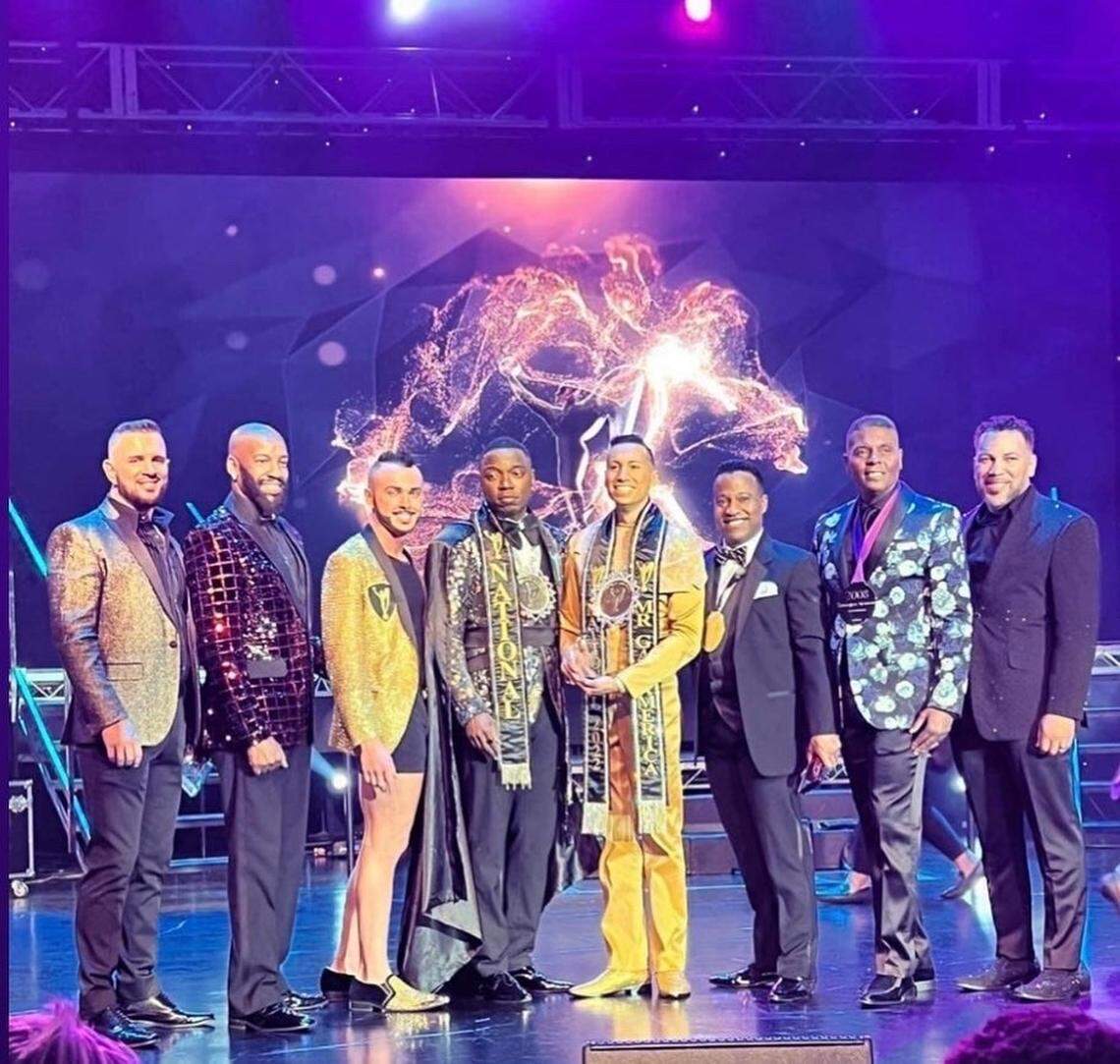 Aniseto Herrera-Lyell poses with past winners of Mr. Gay America.