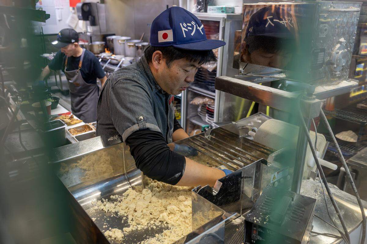 Kenichi Ota, owner of KC Craft Ramen, feeds dough through a noodle sheeter to make fresh ramen noodles Wednesday, Oct. 29, 2025, in Overland Park.