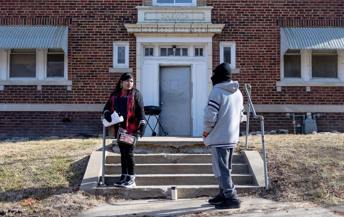 Sofia Be stands outside of a northeast apartment building near her apartment home on Monday, Jan. 23, 2023, in Kansas City. Be and dozens of other tenants were left without heat over the weekend.
